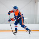 Hockey player in Oilers uniform shooting puck using CCM Ribcor Trigger hockey stick on ice