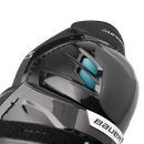Close-up detail of Bauer Supreme F50 Pro shin guard knee cap showing teal padding and textured shell