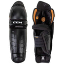CCM Tacks hockey shin guards shown front and back view in black with orange accents
