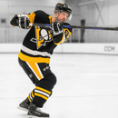 Hockey player in Pittsburgh Penguins jersey shooting with CCM Ribcor Trigger hockey stick on ice