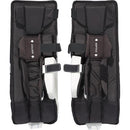 CCM Phenom youth ice hockey goalie leg pads in black and white, back view showing straps and ADPTFIT knee padding