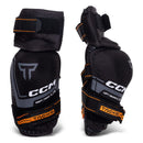 CCM Tacks youth hockey elbow pads shown in left and right pair, black with orange detailing