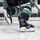 Bauer Supreme F40 Senior ice hockey skates in action on ice rink surface