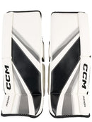 CCM Phenom youth ice hockey goalie leg pads in white and black colorway, top view